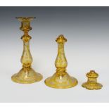A pair of 19th Century Bohemian amber flash glass candlesticks decorated with scrolls, flowers and