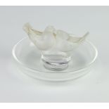 A Lalique pin tray with 2 love birds, engraved lalique france, 10cm diam. One tail feather is