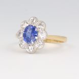 A yellow metal stamped 18k oval sapphire and diamond ring, the centre stone 1.35ct, the 8