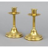 A pair of Victorian brass candlesticks with shaped sconces 15cm h x 10cm diam.