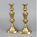 A pair of Victorian brass candlesticks with ejectors 27cm x 11cm