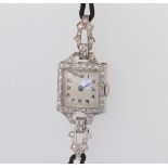 A lady's Art Deco white metal stamped Plat. cocktail watch, contained in a diamond set case on a