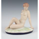 A Royal Dux matt glazed figure of a seated naked lady on an oval base 711 45 21cm