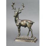 A cast metal door stop in the form of a stag, raised on a rectangular base 30cm h x 17cm w x 7cm d