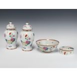 A pair of modern famille rose style baluster vases and covers decorated with flowers 21cm, a ditto