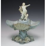 A 19th Century Continental bisque centrepiece with a lady and attendant standing on a shell