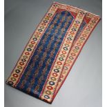 A blue, red and tan ground Afghan runner with geometric design to the centre 427cm x 78cm Small