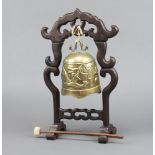 A Chinese gilt metal bronze gong decorated a dragon, raised on a hardwoods stand, complete with