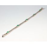 A white metal stamped 750 bracelet set with 5 cabochon cut emeralds, each 0.5ct, 22.6 grams gross,