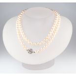 A strand of 92 cultured pearls with a white metal stamped 585 diamond ball clasp, 73cm, pearls