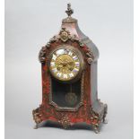 A 19th Century French 8 day striking on bell mantel clock with gilt dial and porcelain Roman