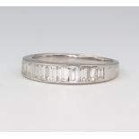 A white metal stamped 585 eleven stone tapered baguette cut diamond ring, approx. 1.2ct, 3.5