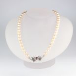 A strand of 45 cultured pearls each approx. 6mm with a white metal stamped 750 ruby and diamond