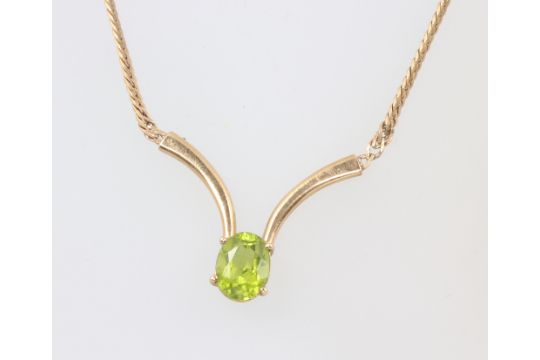 A 9ct yellow gold necklace set with an oval peridot 5.8 grams