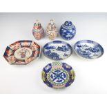 A pair of 18th Century Chinese blue and white willow pattern shallow dishes 20cm (both a/f), an