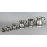 A set of five graduated baluster shaped pewter tankards and a pewter pint tankard