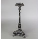 A Rococo style cast iron candlestick raised on a triform base 85cm h x 21cm w