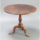An 18th Century circular oak snap top tea table raised on a turned column and tripod base 67cm h x