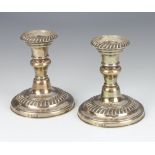 A pair of Edwardian silver dwarf candlesticks with waisted stems Birmingham 1906, maker J Sherwood