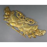 An Eastern embossed brass plaque decorated with two birds 17cm h x 43cm w