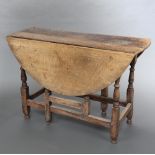An 18th Century bleached oak gateleg dining table fitted a frieze drawer, raised on turned