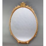 A Georgian style oval plate wall mirror contained in a gilt frame 87cm x 52cm Silvering to the