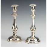 A pair of white metal baluster candlesticks 27cm