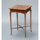 A square Edwardian crossbanded mahogany occasional table raised on club supports with X framed