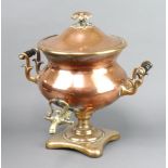 A Georgian copper and brass twin handled tea urn 40cm h x 39cm diamThe ebonised handles to each side