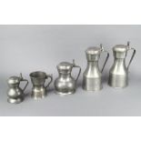A pair of 19th Century waisted pewter lidded tankards, the bases with London touchmarks 24cm h x