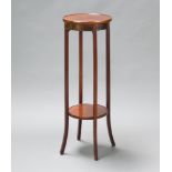A circular mahogany 2 tier jardiniere stand raised on outswept supports 100cm h x 34cm diam.