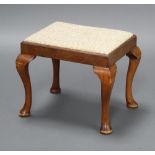 A Queen Anne style rectangular beech dressing table stool with upholstered drop in seat raised on