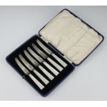 A cased set of 6 Art Deco silver and mother of pearl butter knives by John Sanderson & Son Ltd.