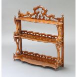 A Victorian carved and pierced walnut 3 tier hanging wall shelf with pierced gallery to the back