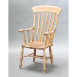 A 19th Century bleached elm and beech stick and rail back hardwood chair, raised on turned