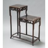 An Oriental rectangular hardwood 2 tier jardiniere stand, raised on shaped outswept supports 87cm