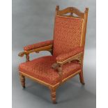 An Edwardian Art Nouveau oak show frame open arm chair, upholstered in red and gold material 114cm h