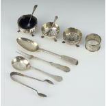 A Victorian silver fiddle pattern dessert spoon London 1890, 3 condiments, a napkin ring, 3