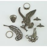A silver and marcasite brooch in the form of an eagle carrying a fish and 2 other brooches, pair
