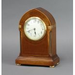 A French bedroom timepiece with enamelled dial and Arabic numerals contained in an inlaid mahogany