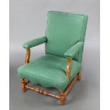 A 1930's beech framed open arm chair upholstered in blue material raised on turned and block