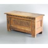 A 17th Century style carved oak coffer of small proportions with hinged lid 44cm h x 91cm w x 36cm d