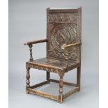 A Victorian carved oak Wainscot chair constructed of old timber, the back carved a portrait bust