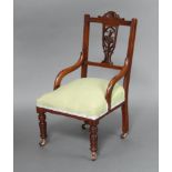 A Victorian carved and pierced walnut slat back nursing chair with overstuffed seat upholstered in