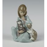 A Lladro figure of a girl holding a kitten 14cm