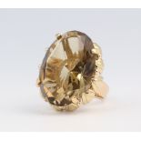 A yellow metal 14ct oval smoky quartz ring, 16.5 grams