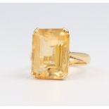 A yellow metal stamped 18ct emerald cut citrine ring size L, 6.2 grams