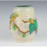A Clarice Cliff moulded oviform jug decorated with parrots no.2/7778 20cm