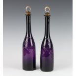 A pair of 19th Century amethyst cut glass bottles decorated with grapes with metal mounted stoppers,
