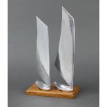 An Art Deco chrome and teak trophy/sculpture in the form of 2 racing yachts, raised on a rectangular